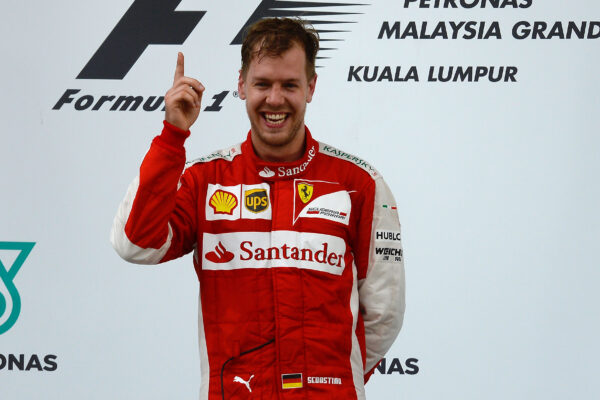 Sebastian Vettel on the podium celebrating his first victory for Ferrari at the 2015 Formula 1 Malaysian Grand Prix