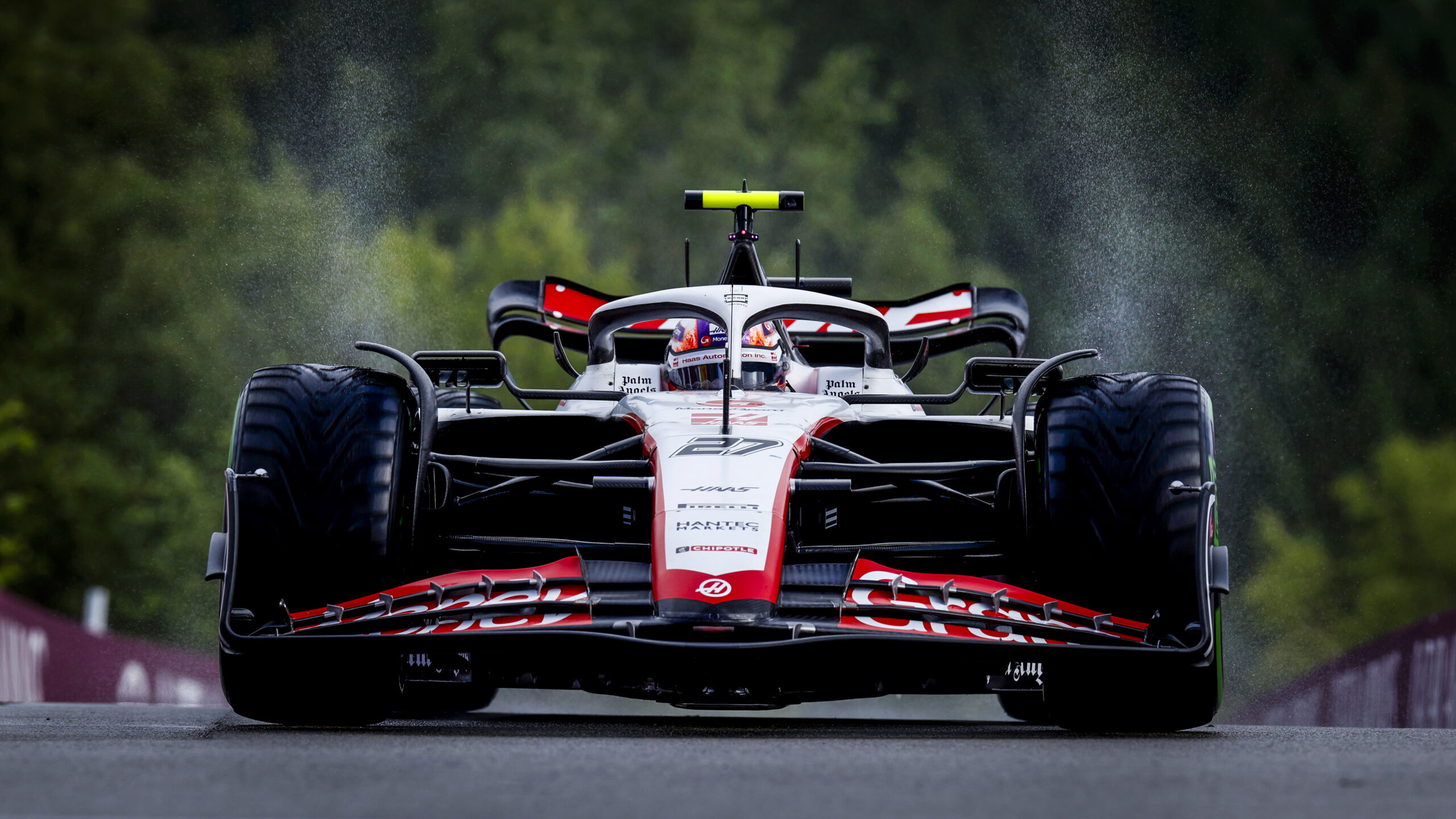 Nico Hulkenberg driving his red and white number 27 Haas car.
