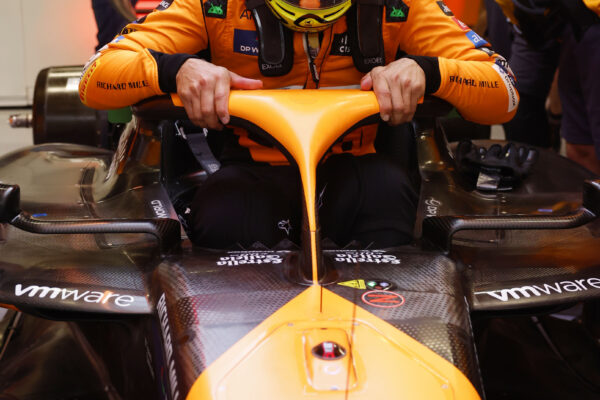 Lando Norris with his MCL38 inside the McLaren garage