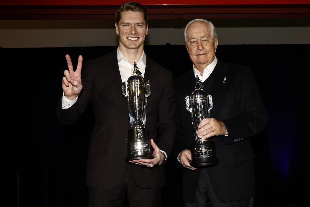 Josef Newgarden collects a Baby Borg trophy after winning the Indy 500 for a second consecutive year in 2024.