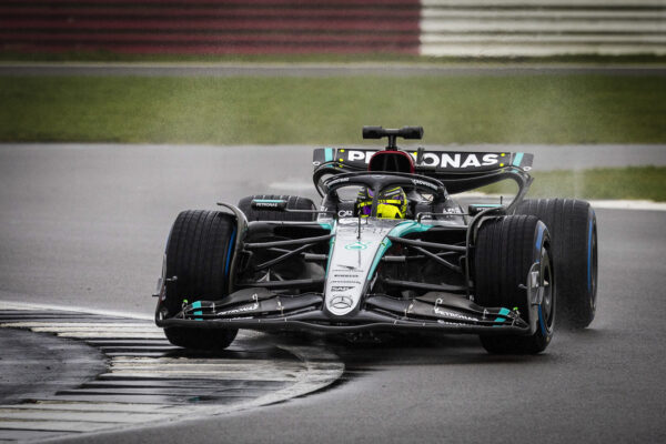 Lewis Hamilton driving the Mercedes W15 in the rain at Silverstone