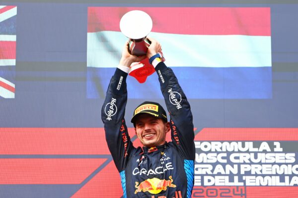 Max Verstappen lifting the trophy on the podium at Imola