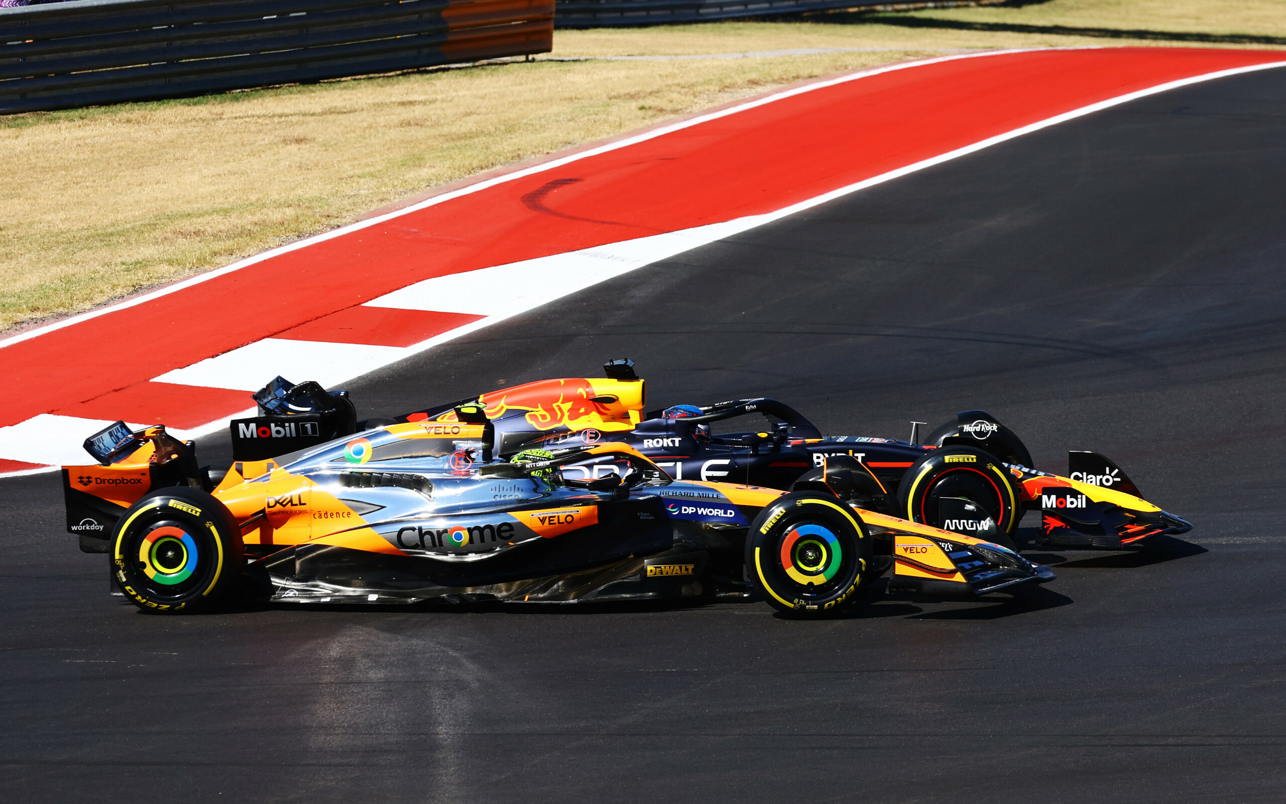 AUSTIN, TEXAS - OCTOBER 20: Max Verstappen of the Netherlands driving the (1) Oracle Red Bull Racing RB20 and Lando Norris of Great Britain driving the (4) McLaren MCL38 Mercedes battle for track position round turn one at the start during the F1 Grand Prix of United States at Circuit of The Americas on October 20, 2024 in Austin, Texas. (Photo by Mark Thompson/Getty Images) // Getty Images / Red Bull Content Pool // SI202410200618 // Usage for editorial use only //