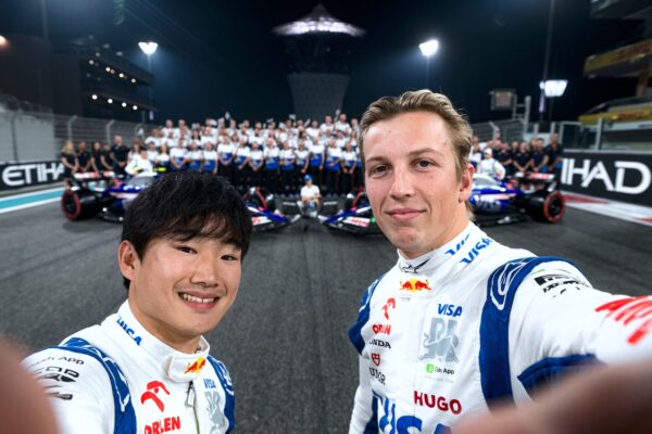 Yuki Tsunoda and Liam Lawson take a selfie with the Visa Cash App RB team after practice ahead of the F1 Abu Dhabi Grand Prix at Yas Marina Circuit in Abu Dhabi, United Arab Emirates