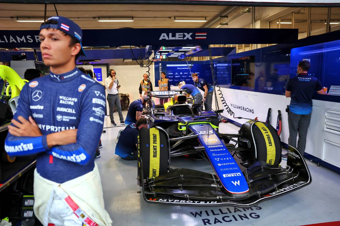 Alex Albon standing behind his car inside the Williams garage in Brazil