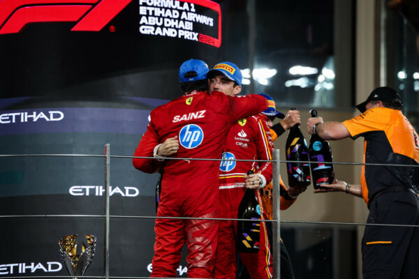 Charles Leclerc embracing teammate Carlos Sainz on the podium at F1 Abu Dhabi GP